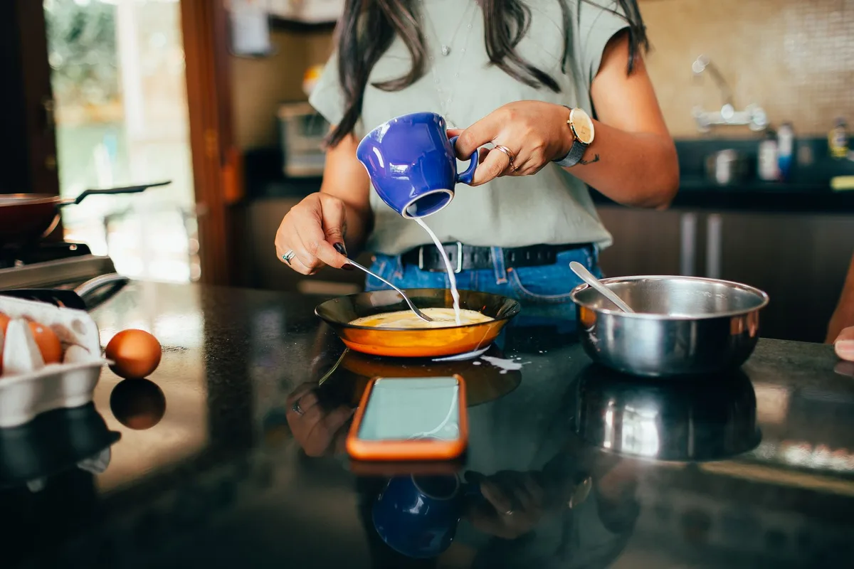 vinegar solution simmering in a pan to release burnt milk