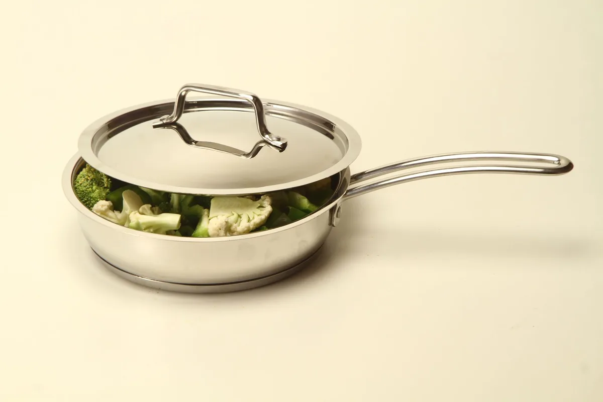stainless steel roaster pan holding a whole roasted turkey